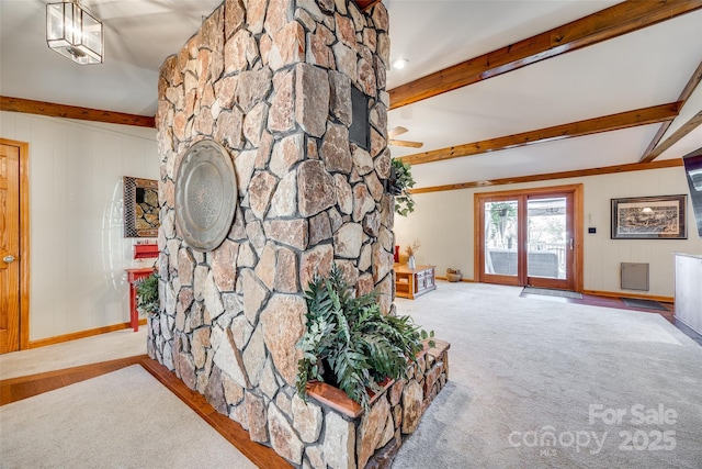 unfurnished living room featuring carpet floors, beam ceiling, and baseboards