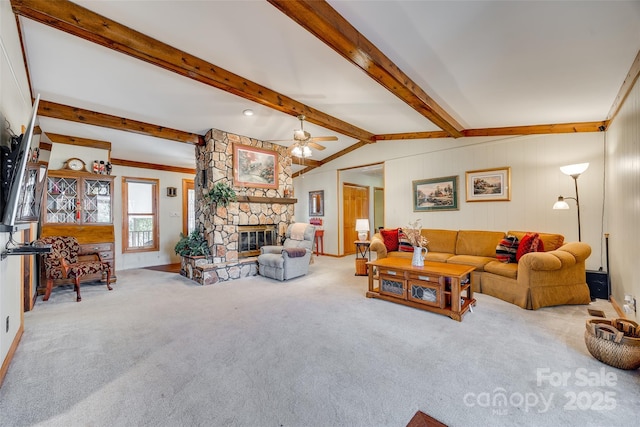 carpeted living room featuring lofted ceiling with beams, a fireplace, and a ceiling fan