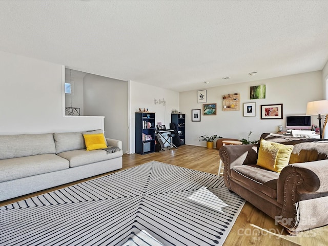 living area featuring a textured ceiling and wood finished floors