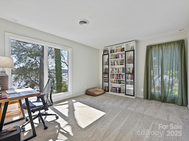 carpeted home office with baseboards and visible vents