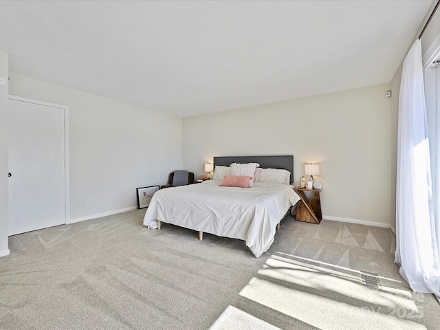 carpeted bedroom with baseboards