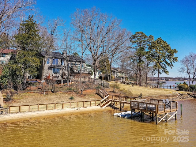 dock area featuring a water view and stairway