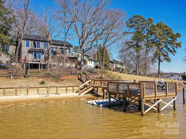 view of dock featuring a water view and stairs