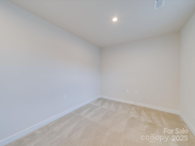 empty room featuring light carpet, visible vents, baseboards, and recessed lighting