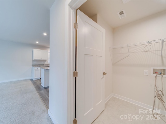 laundry room featuring laundry area, baseboards, hookup for a washing machine, and visible vents