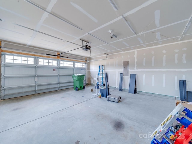 garage with a garage door opener and electric panel