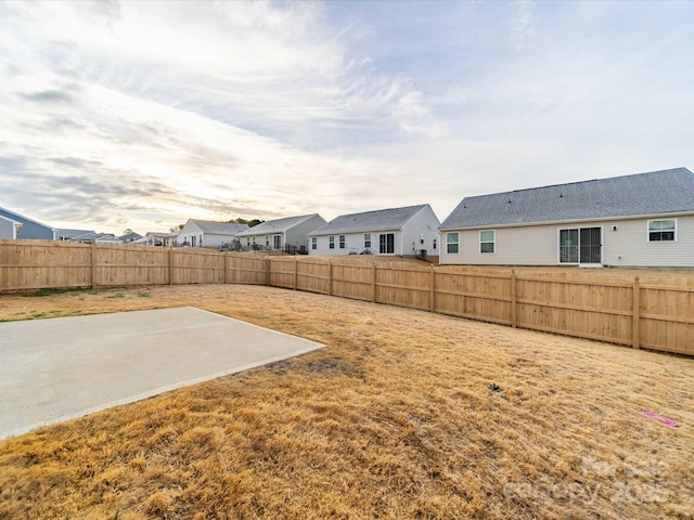 view of yard with a fenced backyard and a residential view