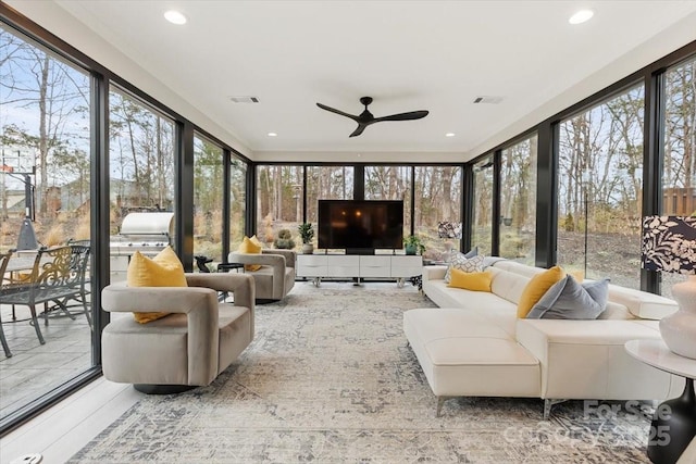 sunroom / solarium featuring ceiling fan and visible vents