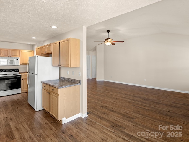 kitchen featuring white appliances, dark countertops, lofted ceiling, dark wood-style flooring, and light brown cabinetry