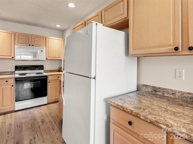 kitchen with a textured ceiling, light brown cabinets, recessed lighting, white appliances, and light wood-type flooring