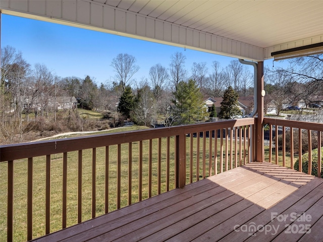 wooden terrace featuring a yard