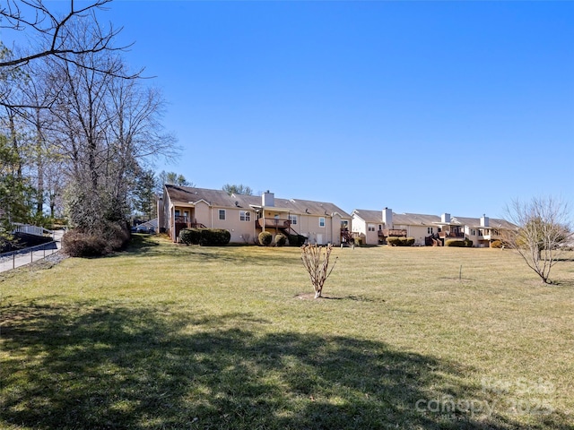 view of yard featuring a residential view and fence