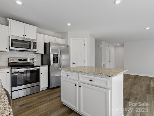 kitchen featuring dark wood-style floors, stainless steel appliances, backsplash, and recessed lighting