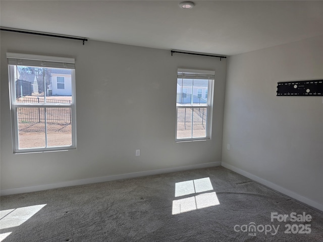 empty room with carpet flooring and baseboards