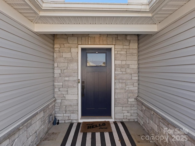 entrance to property featuring stone siding