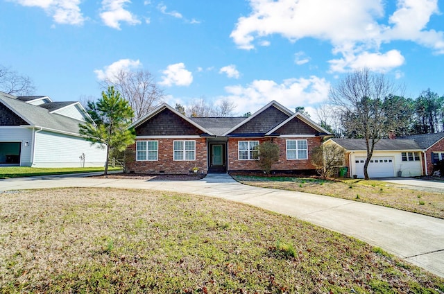 craftsman-style house featuring driveway, crawl space, a front lawn, and brick siding