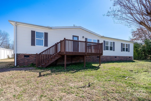 rear view of property with stairway, crawl space, a wooden deck, and a lawn