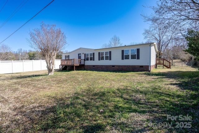 back of property featuring crawl space, fence, a lawn, and a wooden deck