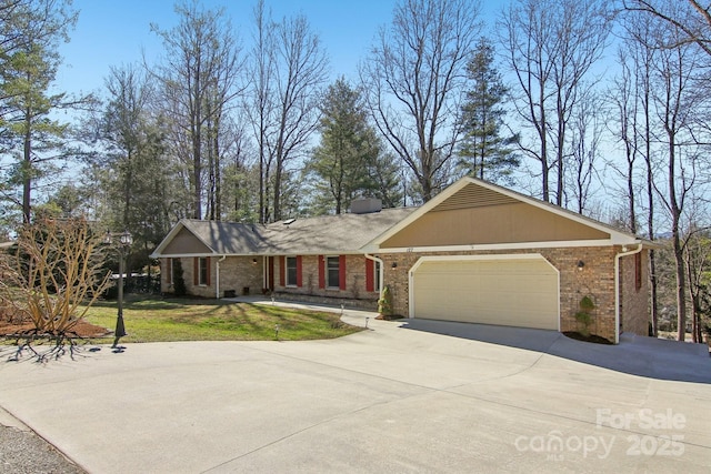 ranch-style house with an attached garage, a front lawn, concrete driveway, and brick siding