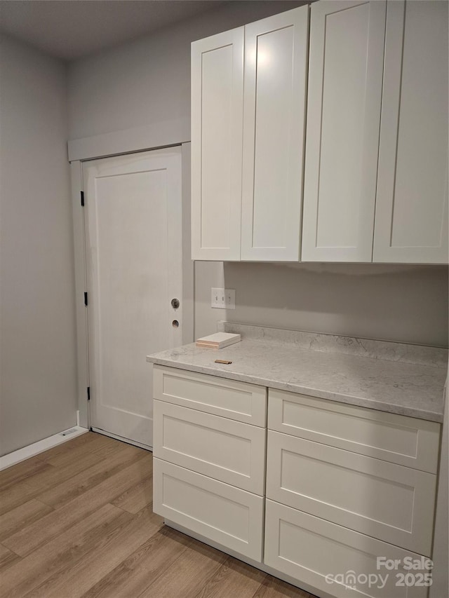 44389 US-52 Hwy N, Richfield, NC 28137 - kitchen featuring white cabinetry, light wood-style floors, and light stone countertops