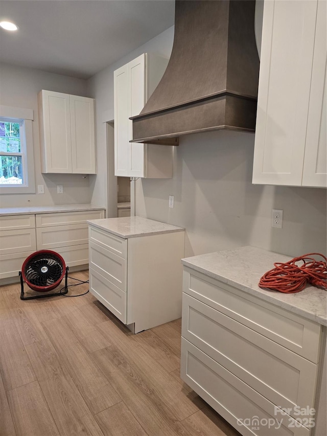 44389 US-52 Hwy N, Richfield, NC 28137 - kitchen featuring custom range hood, white cabinetry, light wood finished floors, light stone countertops, and recessed lighting