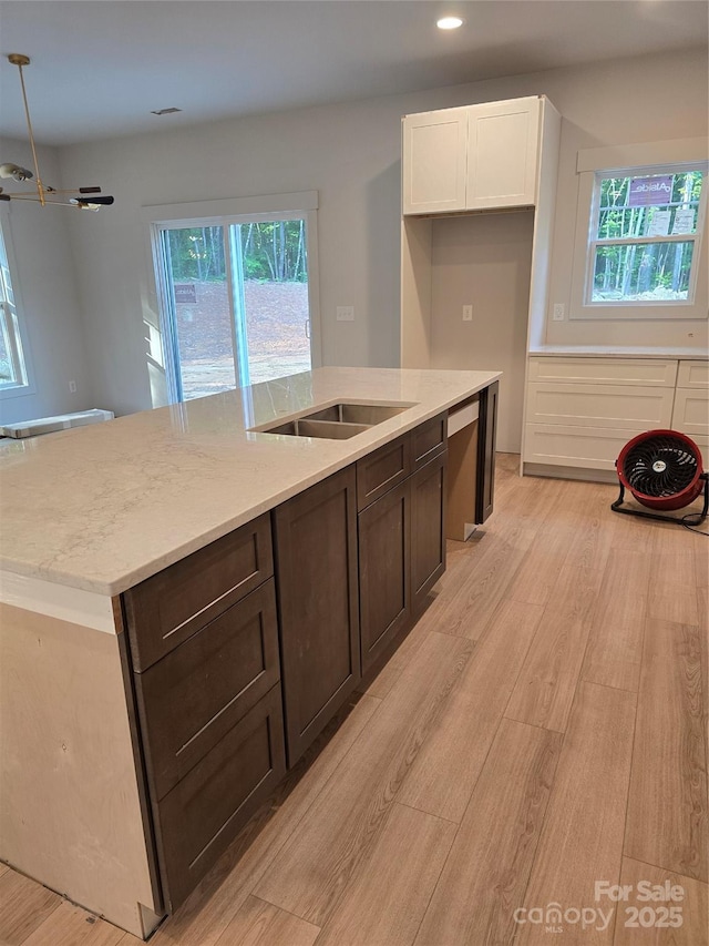 44389 US-52 Hwy N, Richfield, NC 28137 - kitchen with light wood-style floors, an island with sink, white cabinetry, recessed lighting, and dark brown cabinets