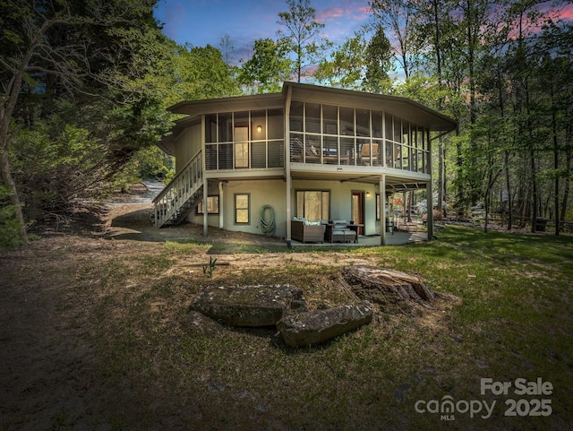 1973 Buffalo Creek Rd, Lake Lure, NC 28746 - rear view of house featuring a lawn, a sunroom, stairs, and a patio