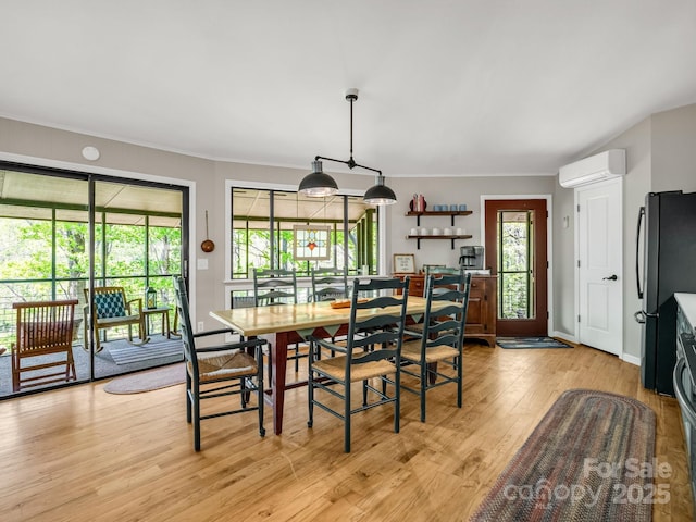 1973 Buffalo Creek Rd, Lake Lure, NC 28746 - dining area featuring light wood finished floors and a wall unit AC