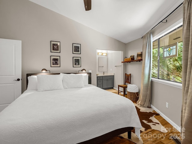 1973 Buffalo Creek Rd, Lake Lure, NC 28746 - bedroom with a ceiling fan, ensuite bathroom, light wood-type flooring, baseboards, and lofted ceiling