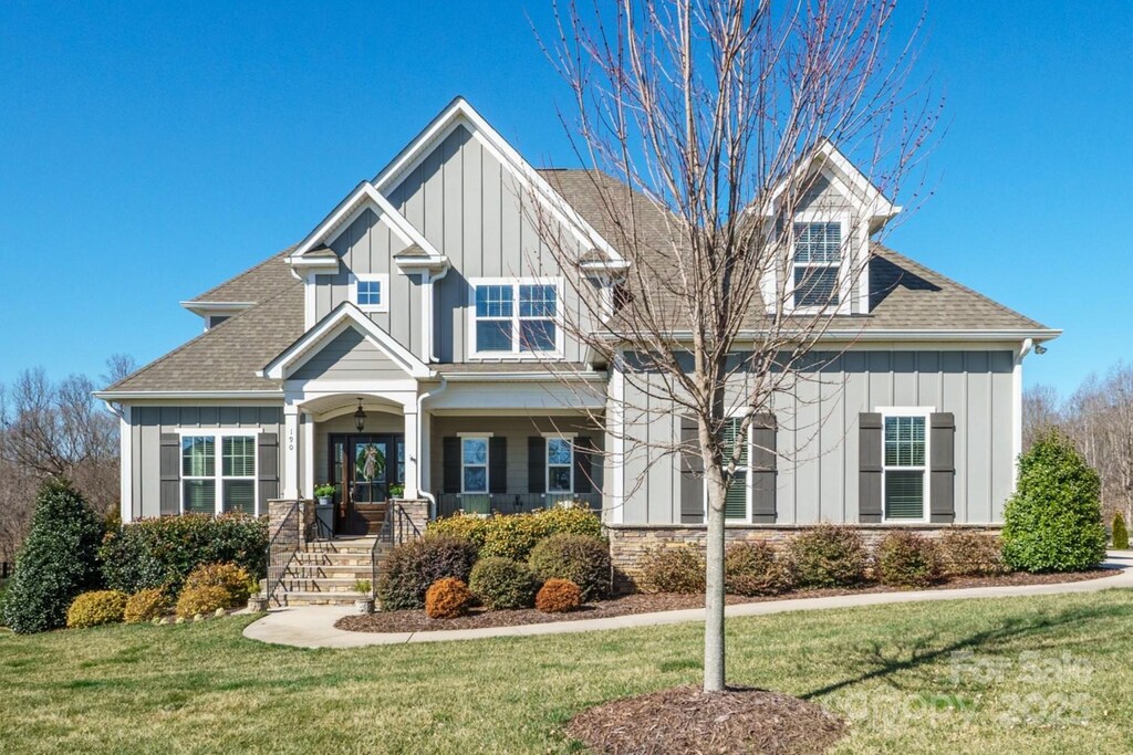 190 Hidden Meadows Dr, Mooresville, NC 28117 - craftsman house with a front yard, board and batten siding, and a shingled roof