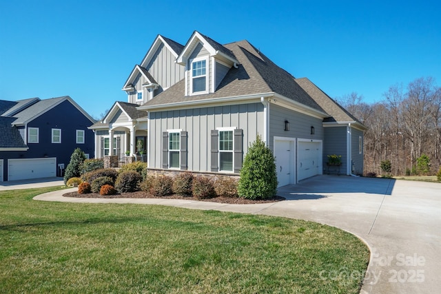 view of front of home featuring an attached garage, concrete driveway, roof with shingles, a front lawn, and board and batten siding