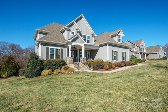 craftsman-style home with a front lawn, board and batten siding, and a shingled roof