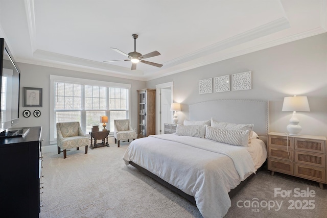 carpeted bedroom featuring a raised ceiling and crown molding