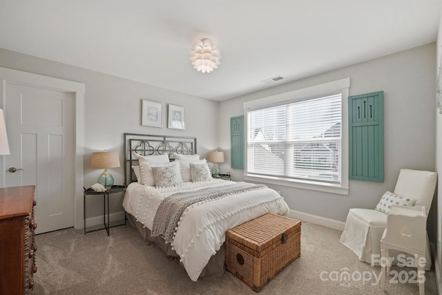 bedroom with baseboards, visible vents, and carpet flooring