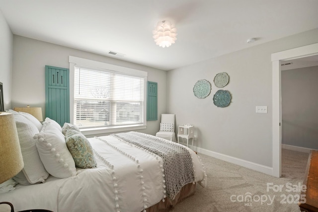 bedroom featuring carpet floors, visible vents, and baseboards