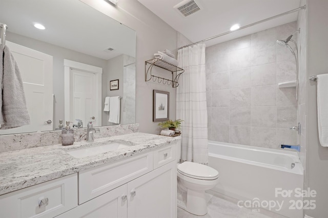 bathroom with shower / bath combination with curtain, visible vents, vanity, and toilet