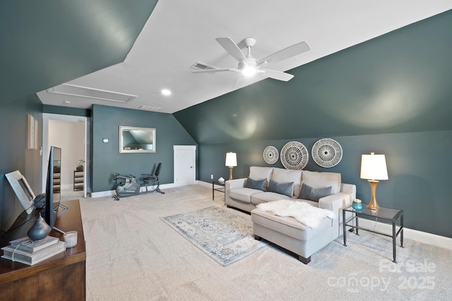 living room featuring attic access, baseboards, vaulted ceiling, and carpet flooring