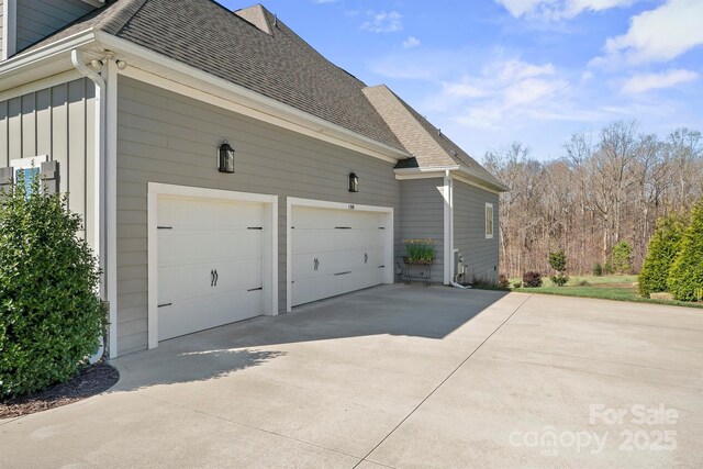 190 Hidden Meadows Dr, Mooresville, NC 28117 - view of home's exterior featuring board and batten siding, driveway, and roof with shingles