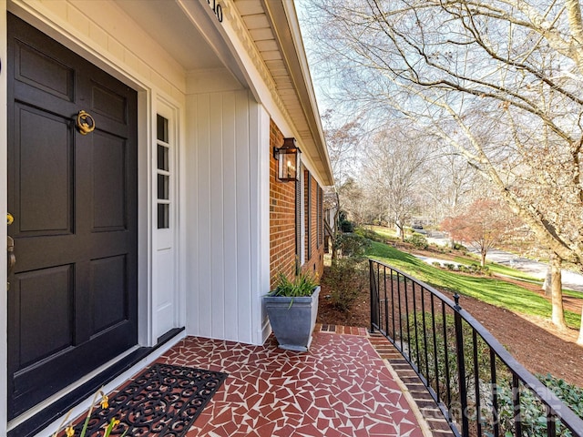 property entrance featuring brick siding