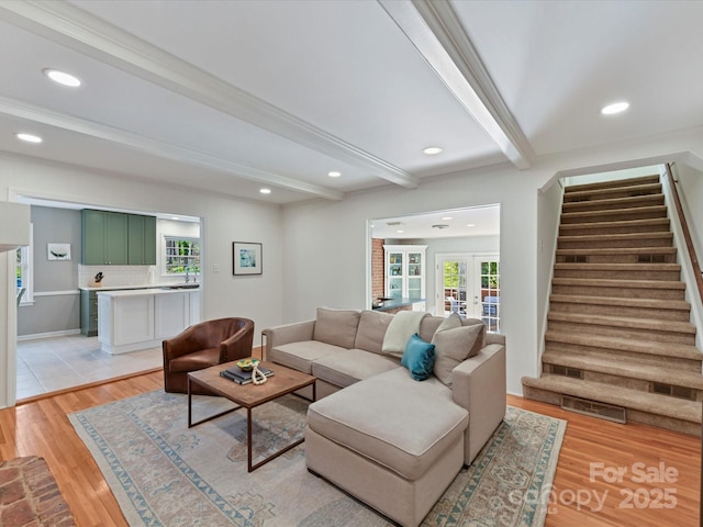 living area with stairway, recessed lighting, light wood-style floors, french doors, and beamed ceiling