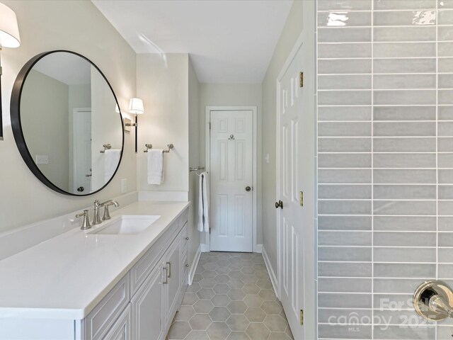 bathroom with tile patterned flooring, vanity, and baseboards