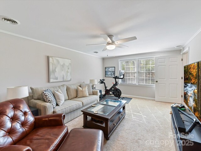 living area featuring visible vents, light carpet, ornamental molding, baseboards, and ceiling fan