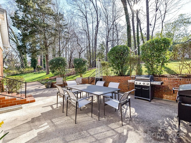 view of patio featuring a grill and outdoor dining area