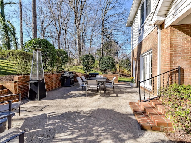 view of patio / terrace featuring outdoor dining space, french doors, and grilling area