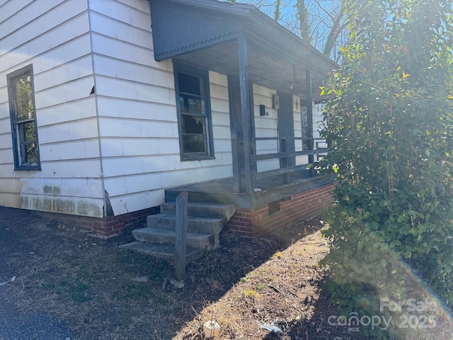 view of home's exterior featuring crawl space and covered porch