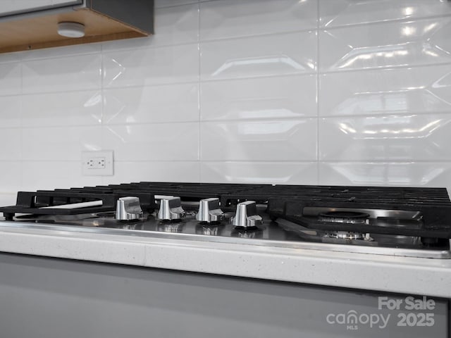 details featuring tasteful backsplash and light countertops