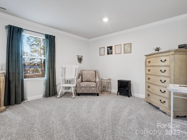 sitting room featuring baseboards, ornamental molding, and carpet flooring