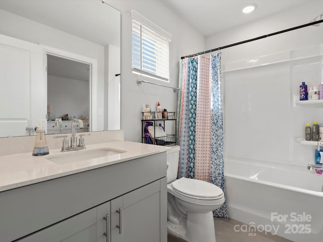 full bathroom featuring shower / bath combo, vanity, and toilet