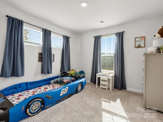 carpeted bedroom with multiple windows, visible vents, and baseboards