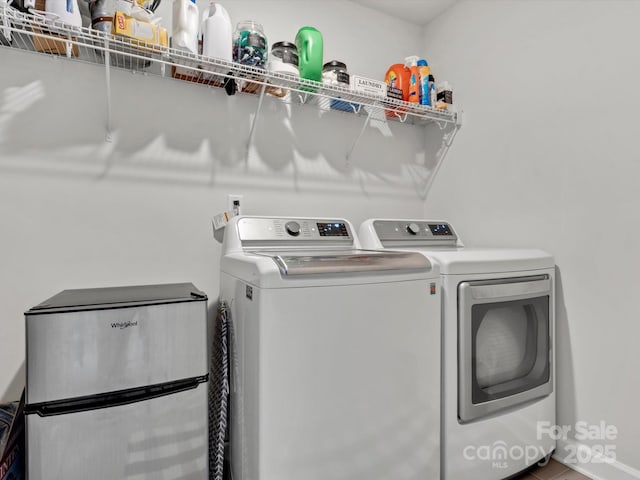 clothes washing area with laundry area and independent washer and dryer